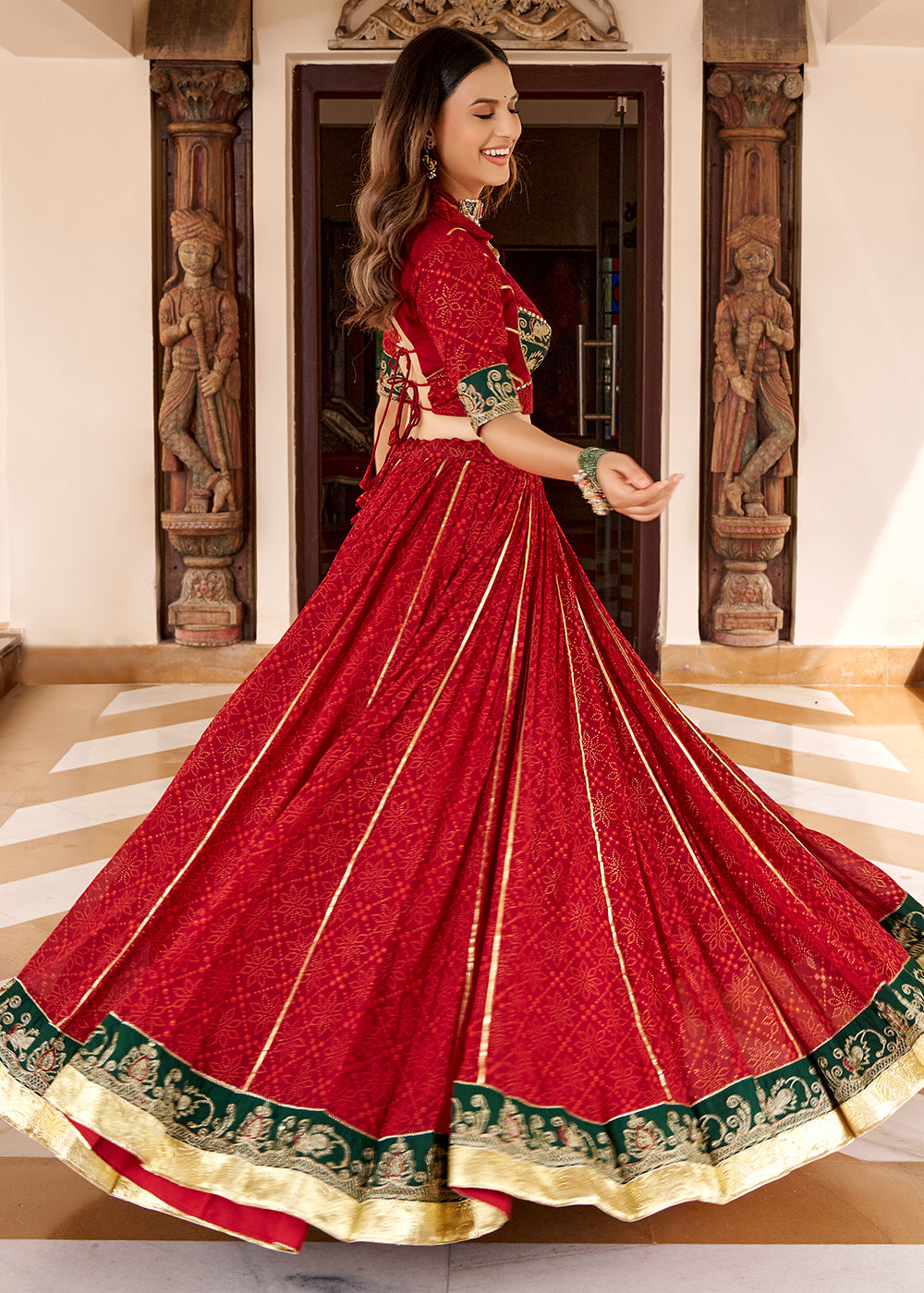 Red &amp; Green Georgette Bandhej Foil Print Navratri Lehenga Choli with Embossed Lace &amp; Gota Patti Detailing