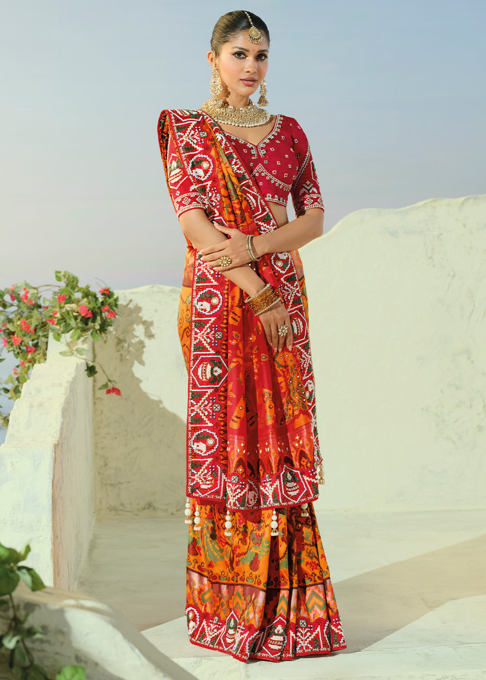 Marigold Orange and Red Patola Silk Designer Saree with Cut-Dana and Mirror Embroidery