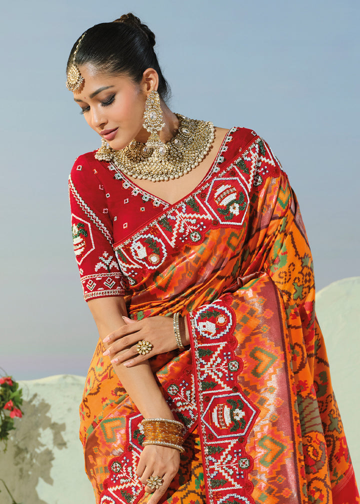 Marigold Orange and Red Patola Silk Designer Saree with Cut-Dana and Mirror Embroidery