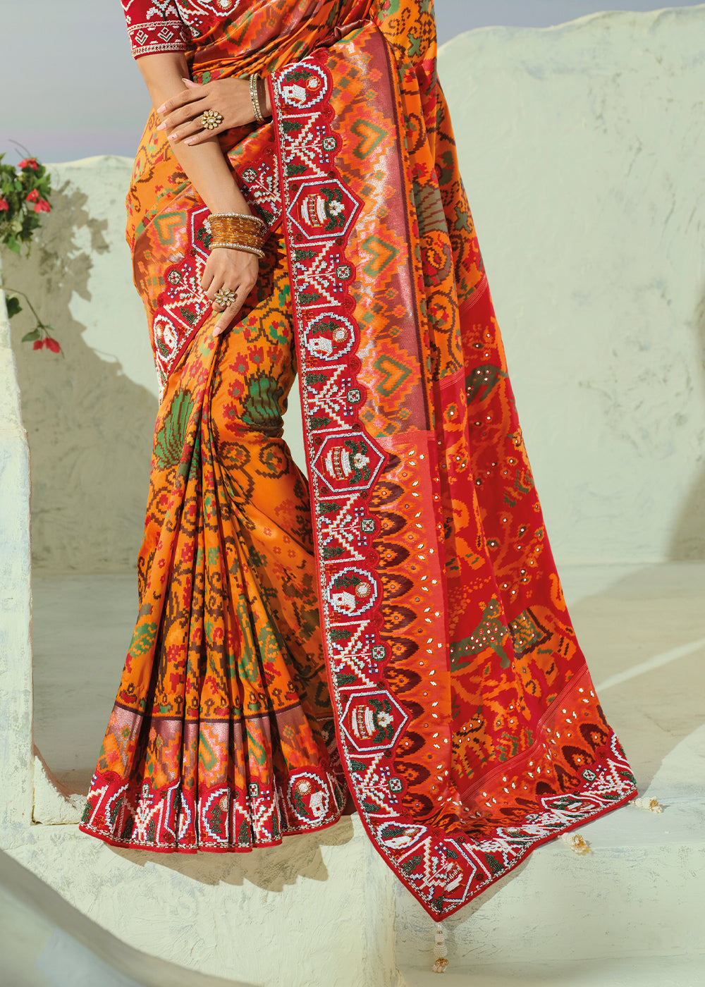 Marigold Orange and Red Patola Silk Designer Saree with Cut-Dana and Mirror Embroidery