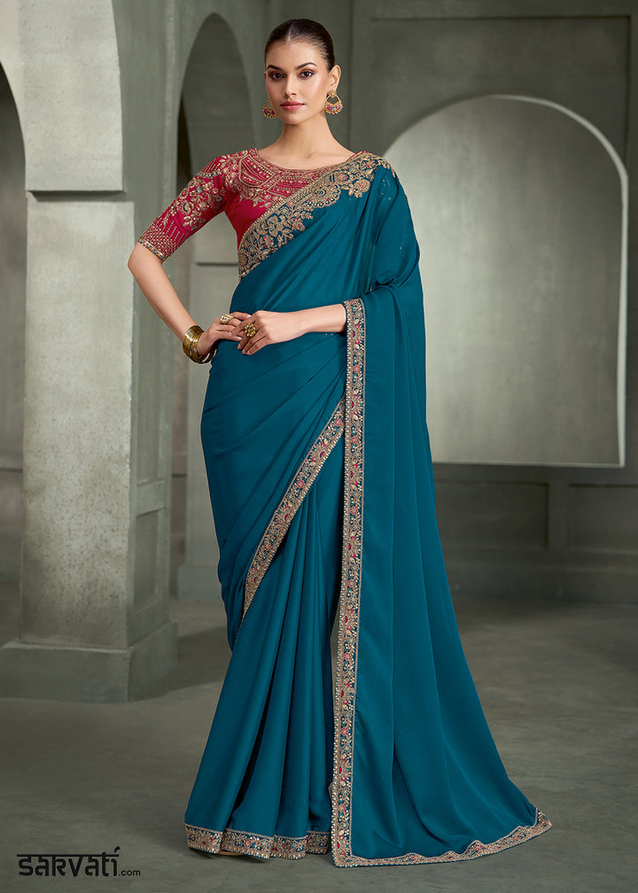 Teal Blue Crepe Silk Saree with Intricate Floral Embroidered Zari Border