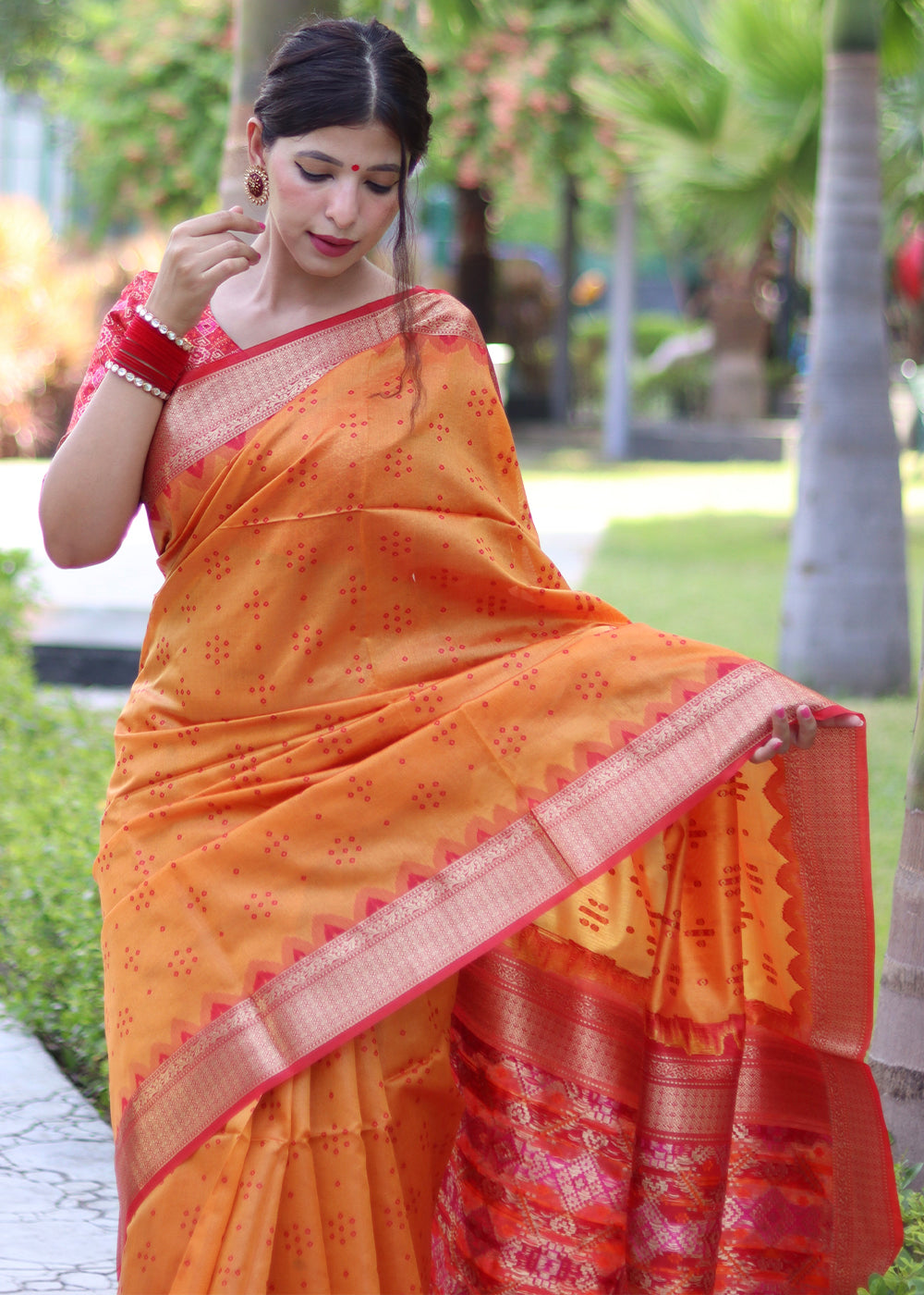 Pumpkin Orange Raw Silk Saree with Intricate Patola Print & Zari Pallu