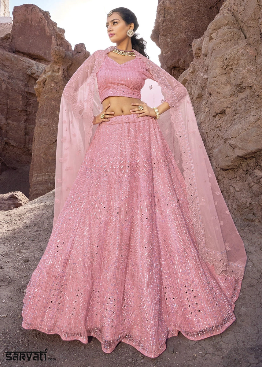 Creamy Pink Net Lehenga Choli Adorned With Cutwork, Mirror, And Zarkan Embellishments - House of Sarvati LLC