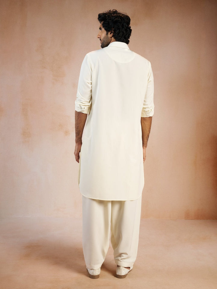 https://cdn.shopify.com/s/files/1/1147/1390/files/mens-cream-solid-silk-blend-pathani-kurta-with-patiala-pyjama-setvasmpt1045crnp-36vastramay-1029369.jpg?v=1773990380
